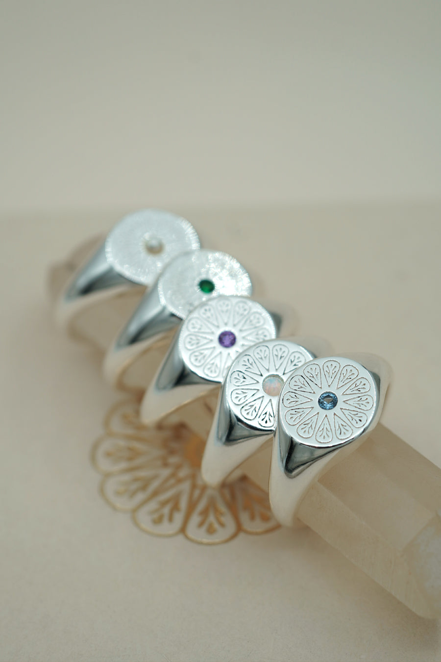 Silver Amethyst Birthstone Signet Rings stacked on crystal