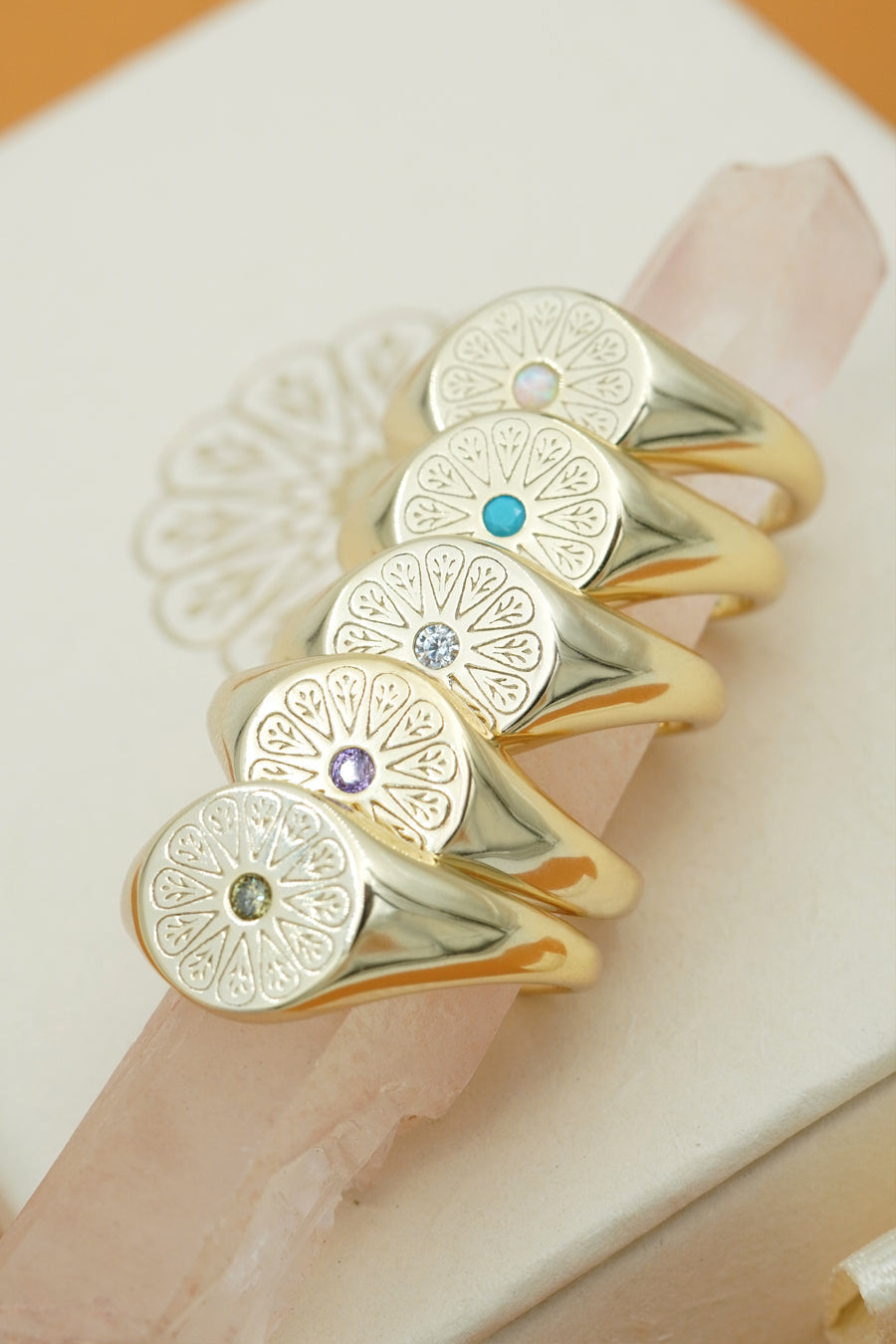 Gold May Crystal Signet Birthstone stacked on down with other rings