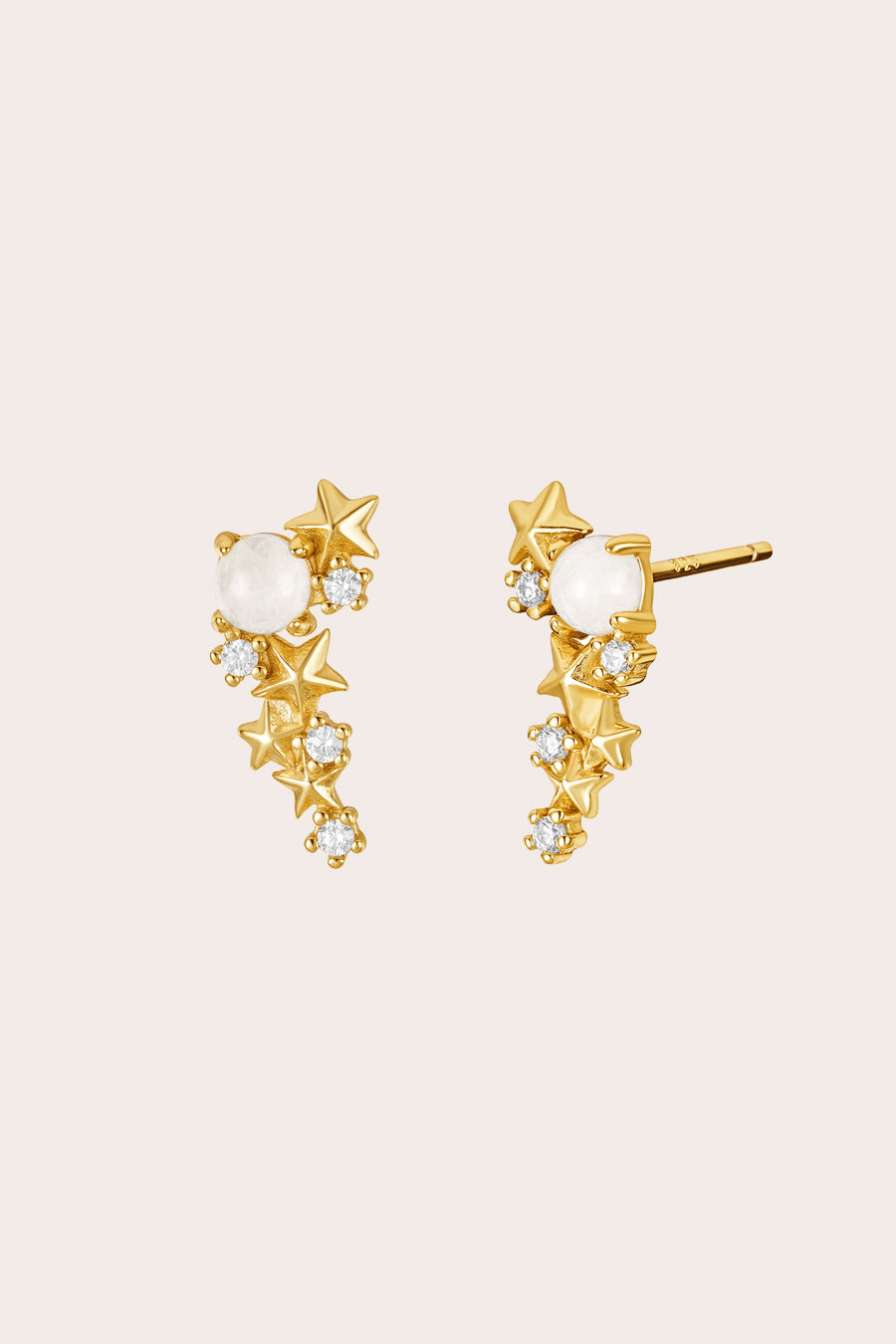 Gold Matariki Earrings jewellery on cream background