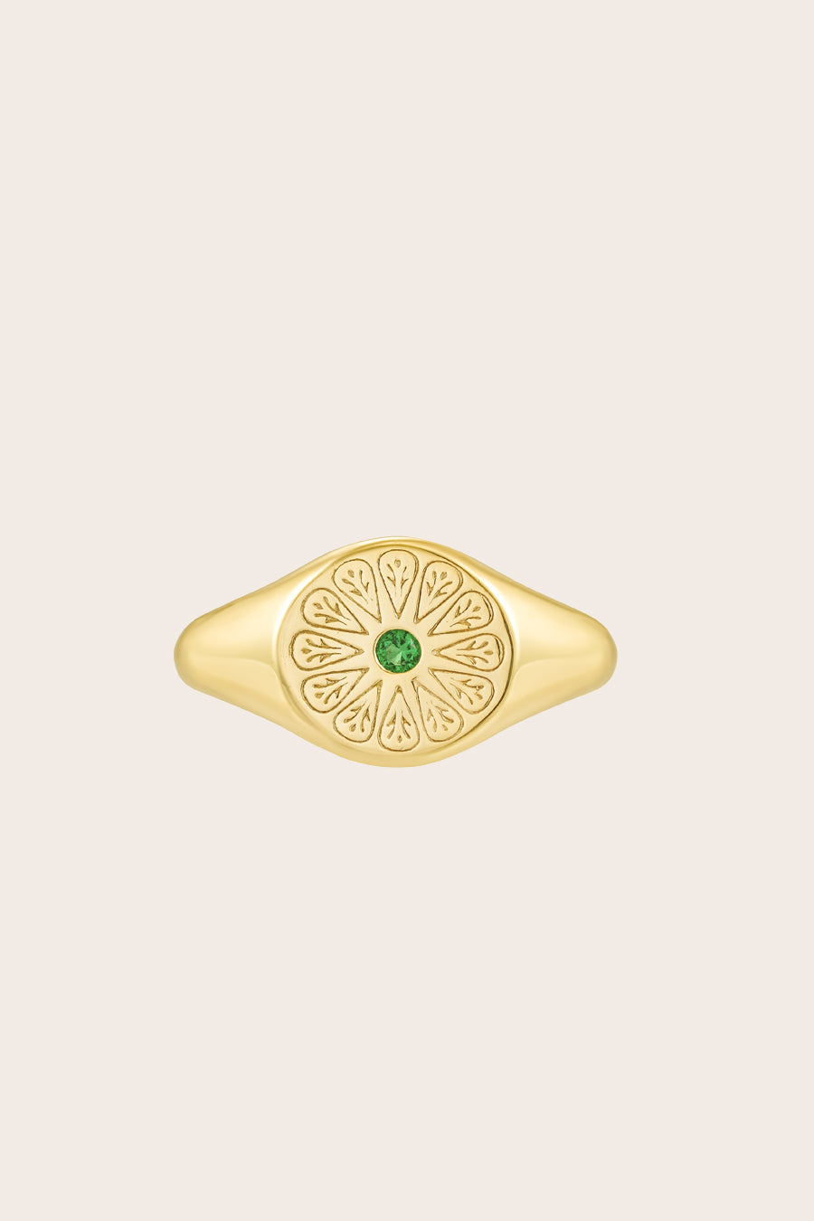 Gold May Emerald Birthstone Ring on cream background